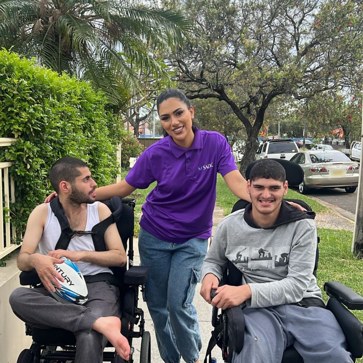 SADC support worker with two participants on a neighbourhood walk