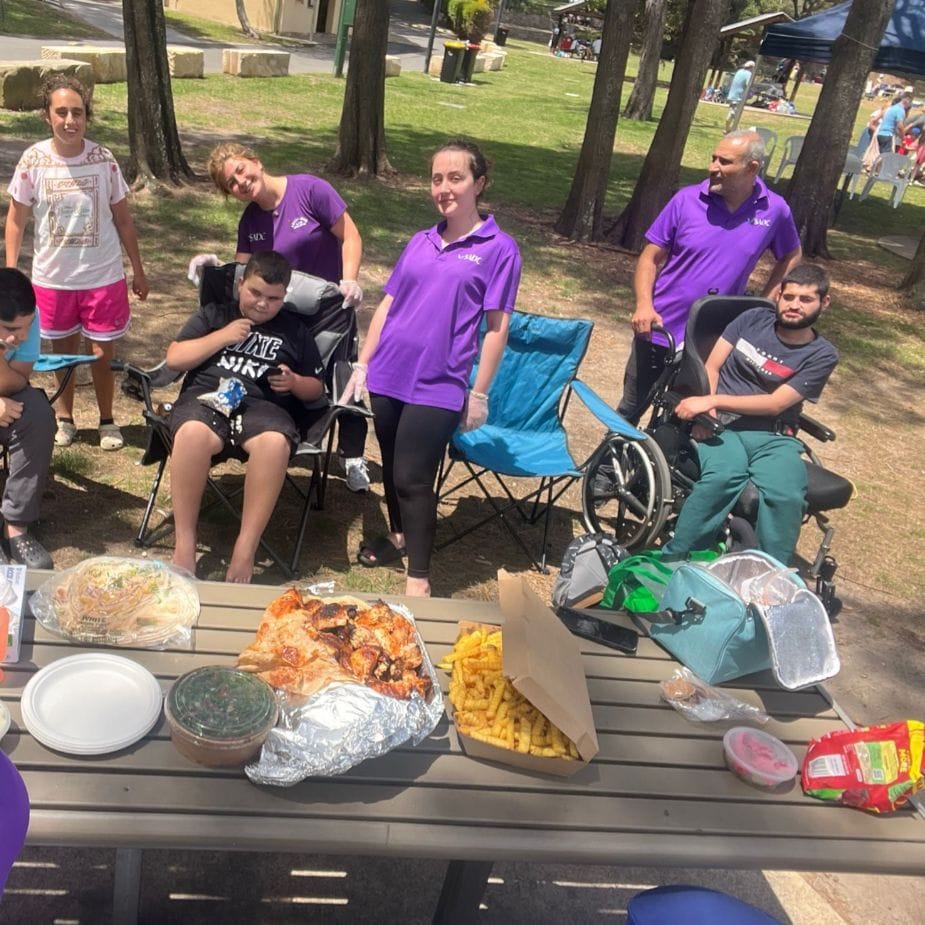 SADC support workers and participants at a group picnic in the park